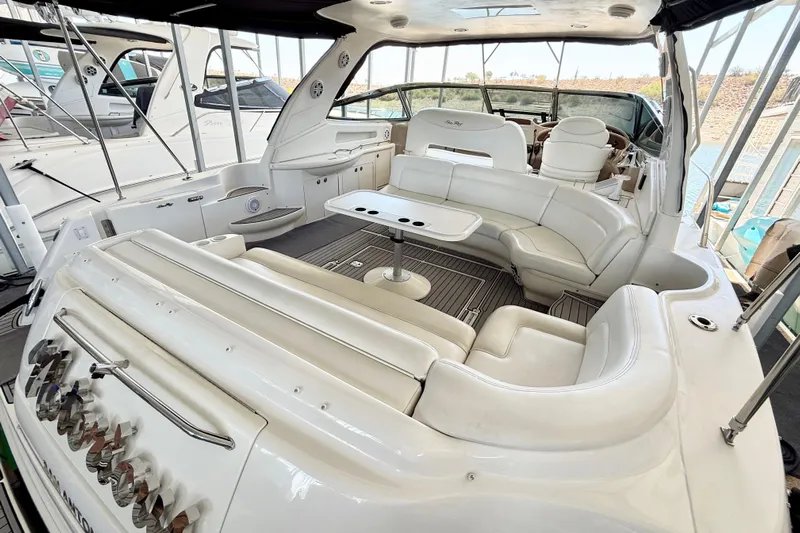 Notorious Yacht Photos Pics 2003 Sea Ray 460 Sundancer yacht interior with white seating and table.