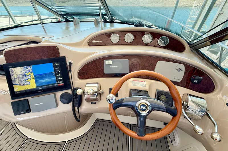 Notorious Yacht Photos Pics Helm of 2003 Sea Ray 460 Sundancer with navigation system and wooden steering wheel.
