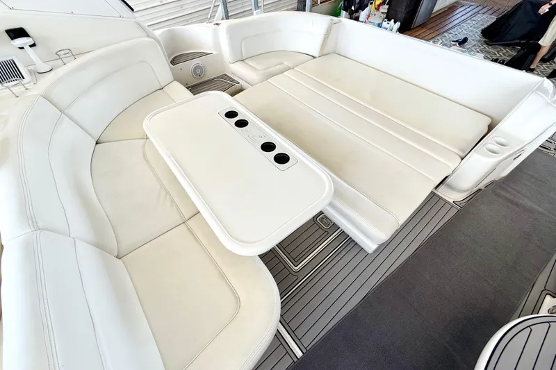 Notorious Yacht Photos Pics 2003 Sea Ray 460 Sundancer interior with white seating and table, showcasing luxury design.