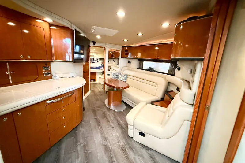 Notorious Yacht Photos Pics Luxurious interior of 2003 Sea Ray 460 Sundancer yacht with elegant wood and leather furnishings.