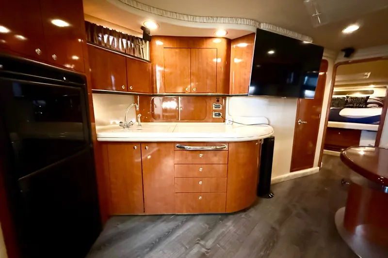 Notorious Yacht Photos Pics Luxurious 2003 Sea Ray 460 Sundancer yacht interior with modern kitchen and sleek wood cabinetry.