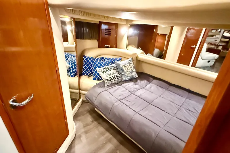 Notorious Yacht Photos Pics Cozy cabin interior of 2003 Sea Ray 460 Sundancer with plush bedding and decorative pillows.