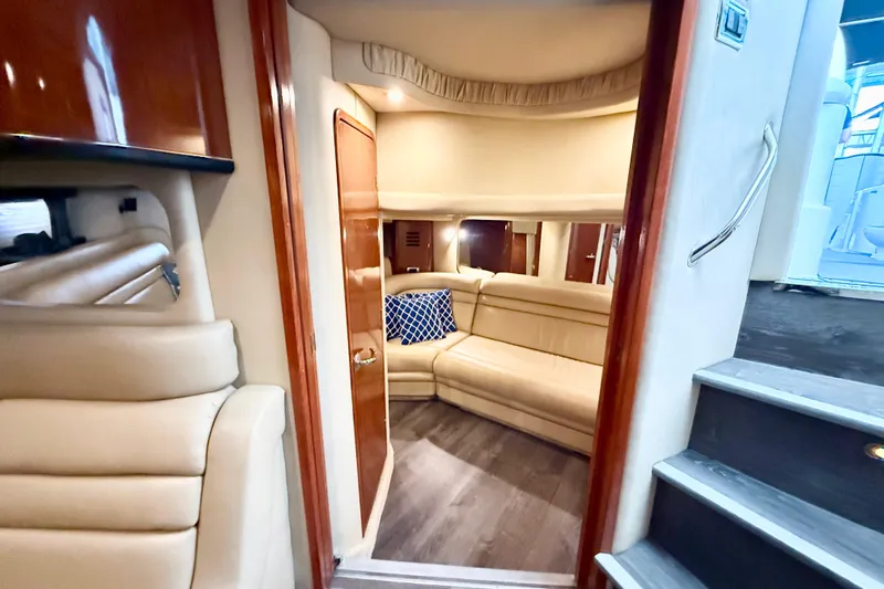 Notorious Yacht Photos Pics Luxurious interior of 2003 Sea Ray 460 Sundancer yacht with beige seating and blue cushion.