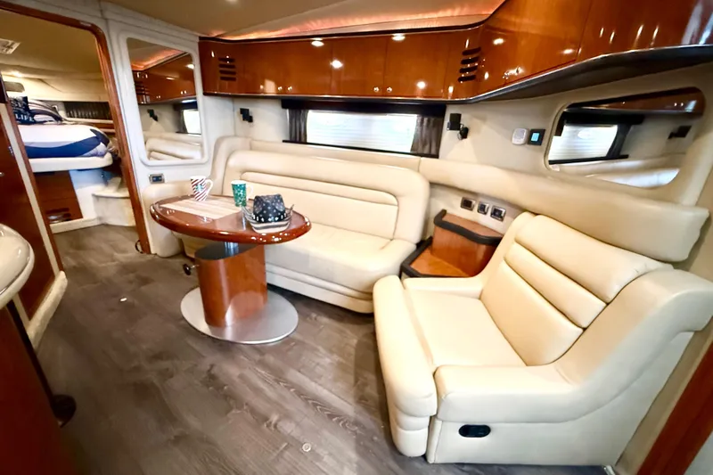 Notorious Yacht Photos Pics Luxurious interior of 2003 Sea Ray 460 Sundancer yacht with cream leather seating and wooden accents.