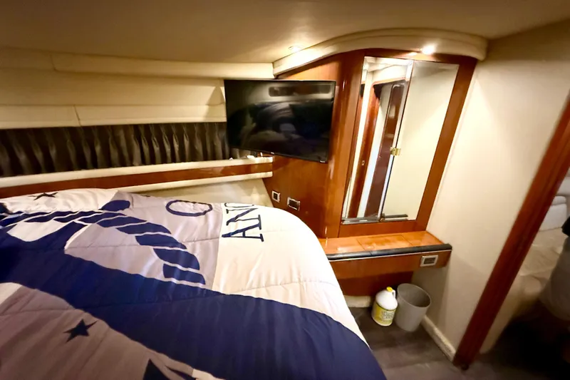 Notorious Yacht Photos Pics Luxurious cabin interior of 2003 Sea Ray 460 Sundancer yacht with TV and bedding.