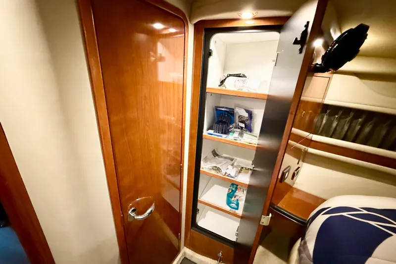 Notorious Yacht Photos Pics Interior of 2003 Sea Ray 460 Sundancer showing wooden cabinet with open shelves.