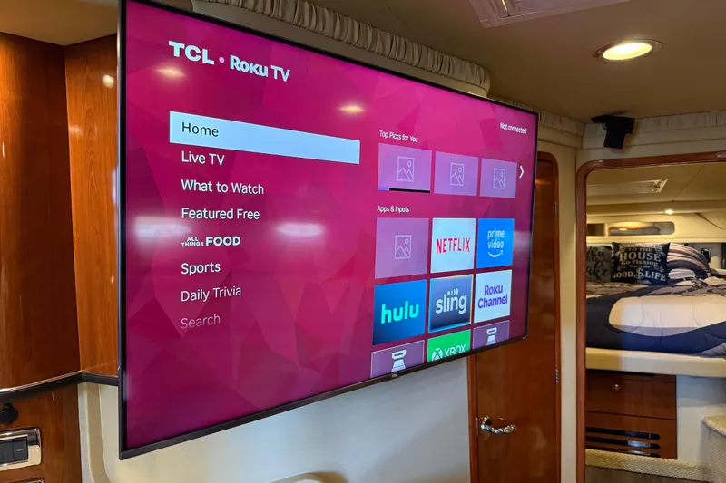 Notorious Yacht Photos Pics TCL Roku TV inside 2003 Sea Ray 460 Sundancer yacht, displaying streaming apps.