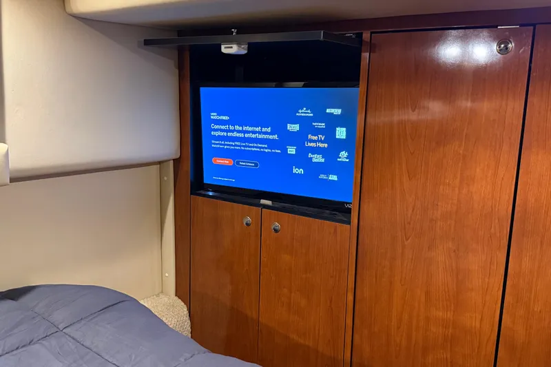 Notorious Yacht Photos Pics Interior of 2003 Sea Ray 460 Sundancer with TV and wooden cabinetry.