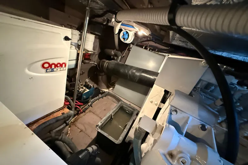 Notorious Yacht Photos Pics Engine room of 2003 Sea Ray 460 Sundancer with Onan generator and mechanical components.