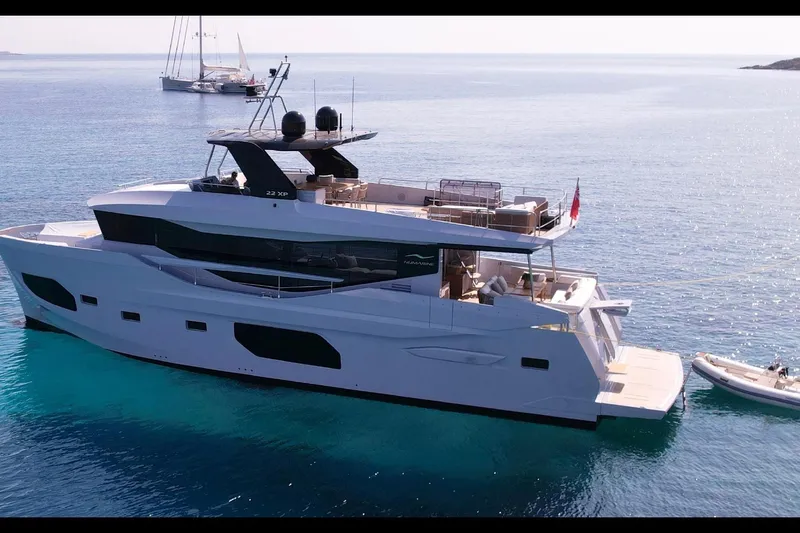  Yacht Photos Pics 2023 Numarine 22 XP yacht on serene blue waters, showcasing luxury and modern design.