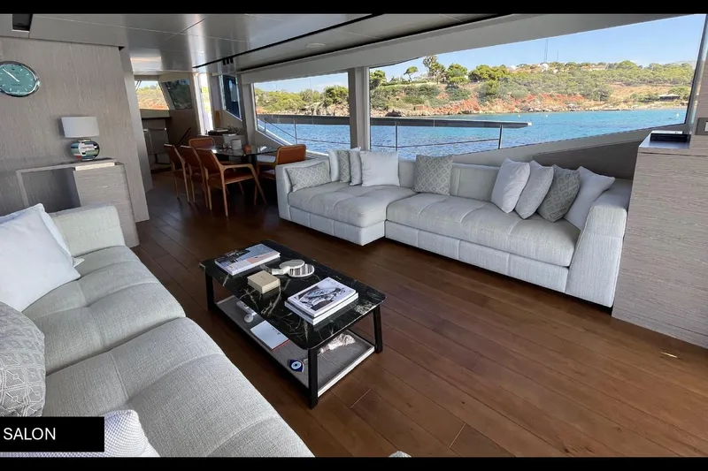  Yacht Photos Pics Luxurious salon interior of 2023 Numarine 22 XP yacht with elegant furnishings and scenic views.