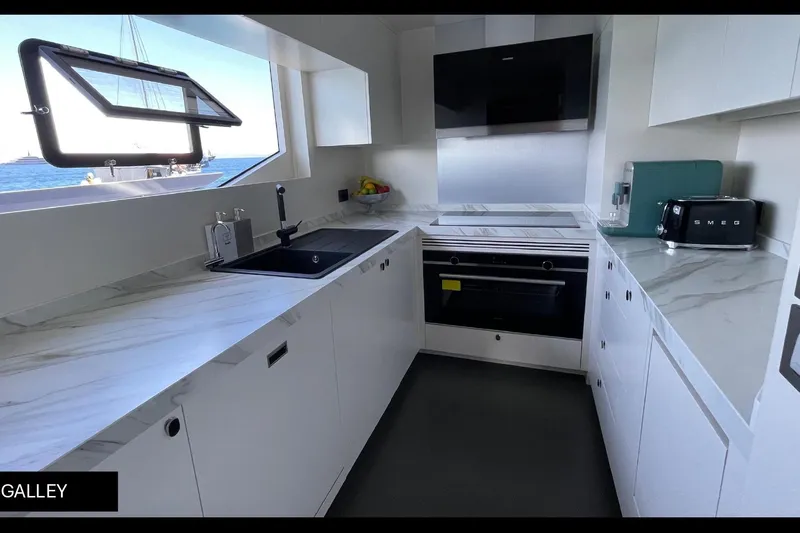  Yacht Photos Pics Modern galley kitchen in 2023 Numarine 22 XP yacht with sleek design and ocean view.