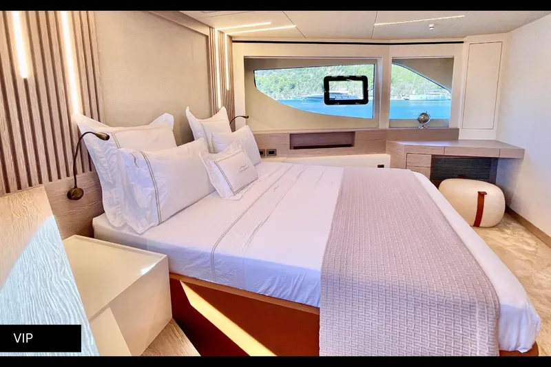  Yacht Photos Pics Luxurious bedroom interior of 2023 Numarine 22 XP yacht with elegant design and scenic window view.