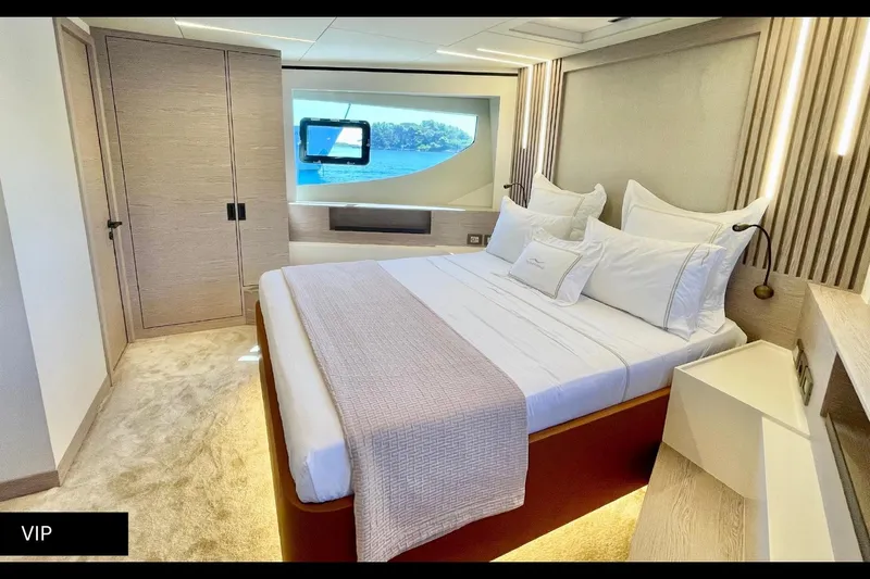  Yacht Photos Pics Luxurious 2023 Numarine 22 XP yacht bedroom with elegant decor and scenic window view.