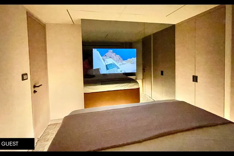  Yacht Photos Pics Guest bedroom in 2023 Numarine 22 XP yacht with modern decor and TV.