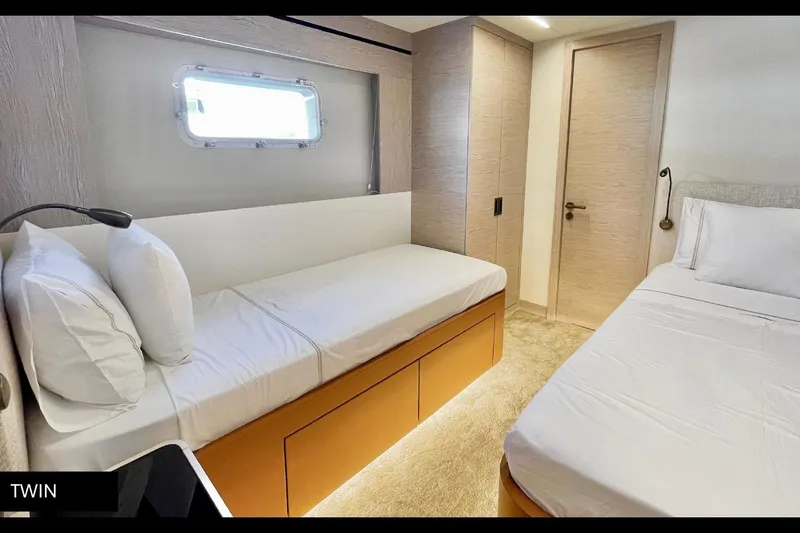  Yacht Photos Pics 2023 Numarine 22 XP yacht twin bedroom with modern design and cozy beds.