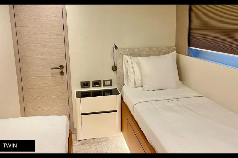  Yacht Photos Pics Twin bedroom interior of 2023 Numarine 22 XP yacht, featuring modern design and cozy beds.