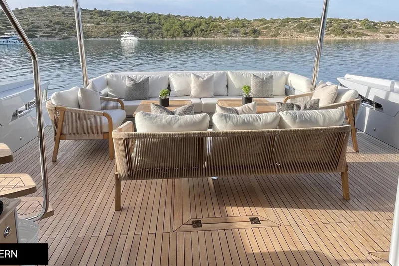  Yacht Photos Pics Luxurious 2023 Numarine 22 XP yacht deck with elegant seating and scenic water view.
