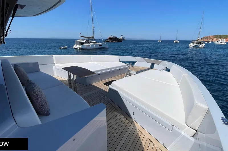  Yacht Photos Pics Luxurious 2023 Numarine 22 XP yacht deck with seating, ocean view, and surrounding boats.