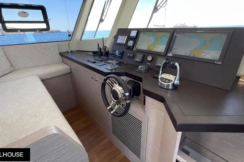  Yacht Photos Pics 2023 Numarine 22 XP yacht helm with navigation screens and steering wheel.