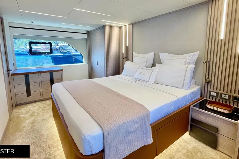  Yacht Photos Pics Luxurious bedroom interior of 2023 Numarine 22 XP yacht with modern design and scenic window view.
