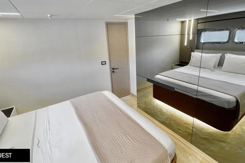  Yacht Photos Pics Luxurious bedroom interior of 2023 Numarine 22 XP yacht with modern design and mirrored wall.