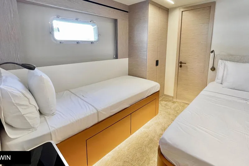  Yacht Photos Pics 2023 Numarine 22 XP yacht cabin with twin beds and modern decor.