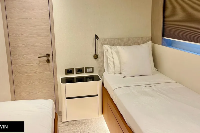  Yacht Photos Pics 2023 Numarine 22 XP yacht cabin with twin beds and modern decor.