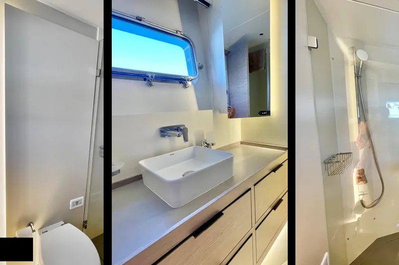  Yacht Photos Pics Luxurious 2023 Numarine 22 XP yacht bathroom with modern sink, shower, and toilet.