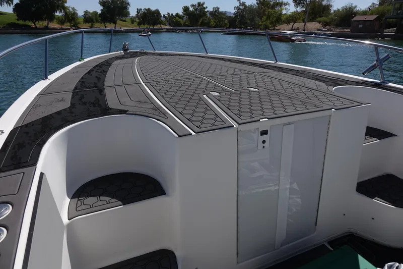 Shaka Yacht Photos Pics 2002 Fountain 38 CC Tournament Edition boat deck on a calm lake.