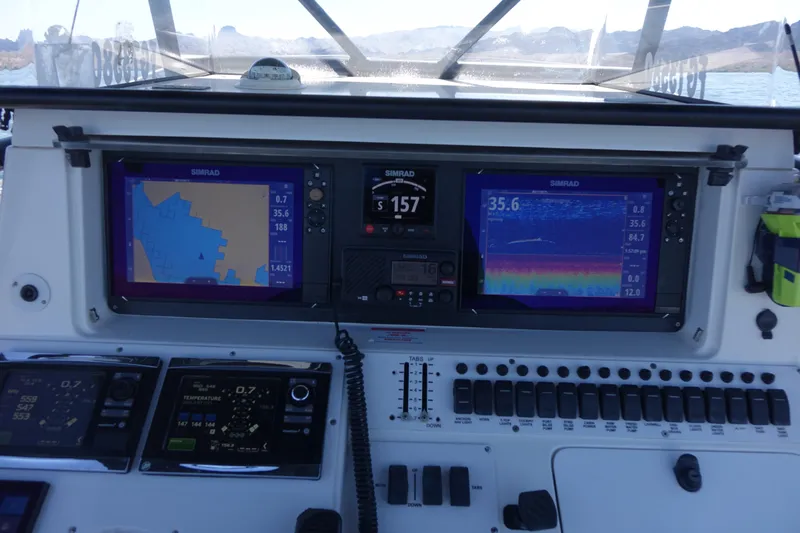 Shaka Yacht Photos Pics Control panel of 2002 Fountain 38 CC Tournament Edition boat with navigation screens.