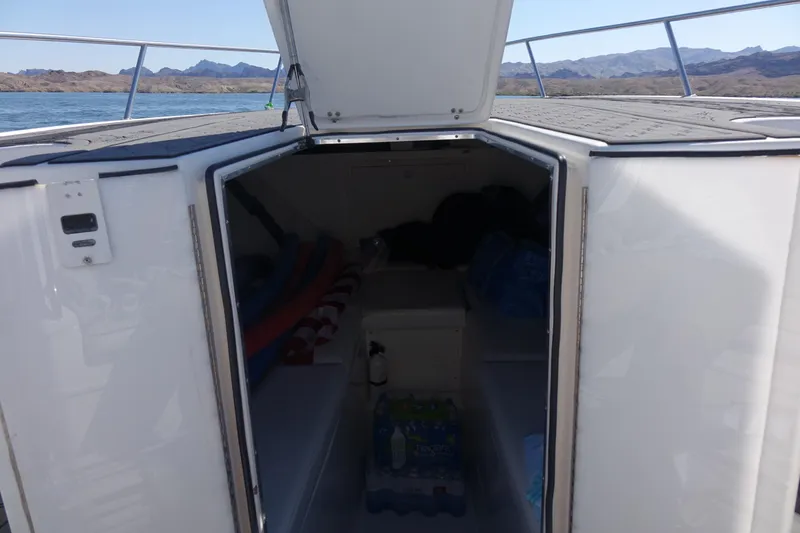 Shaka Yacht Photos Pics 2002 Fountain 38 CC Tournament Edition boat cabin with open hatch, scenic water view.