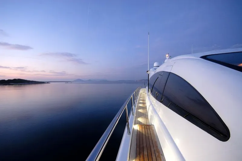 Ares Yacht Photos Pics Mangusta 108 yacht cruising at sunset, 2005 model, serene ocean view.