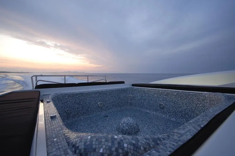 Ares Yacht Photos Pics Luxurious 2005 Mangusta 108 yacht with a jacuzzi at sunset.