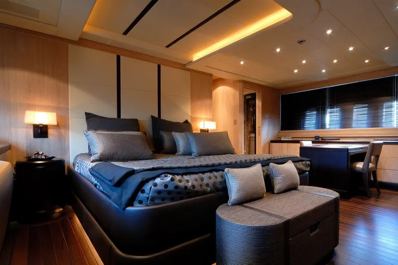 Ares Yacht Photos Pics Luxurious bedroom interior on 2005 Mangusta 108 yacht, featuring elegant decor and ambient lighting.