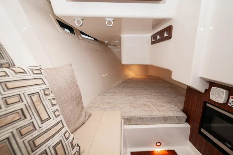 Silver Lining Yacht Photos Pics 2023 Pursuit DC 365 Dual Console cabin interior with cushions and modern amenities.