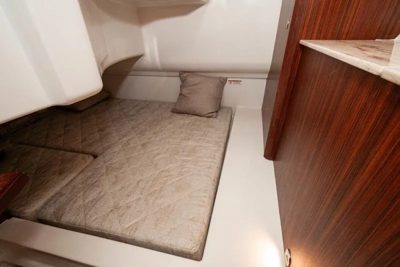 Silver Lining Yacht Photos Pics 2023 Pursuit DC 365 Dual Console cabin interior with cushioned sleeping area.