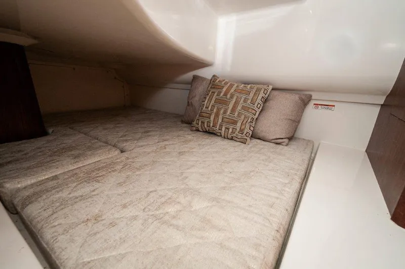 Silver Lining Yacht Photos Pics 2023 Pursuit DC 365 Dual Console cabin interior with cozy bedding and decorative pillows.