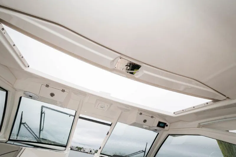Silver Lining Yacht Photos Pics 2023 Pursuit DC 365 Dual Console boat interior with open sunroof view.