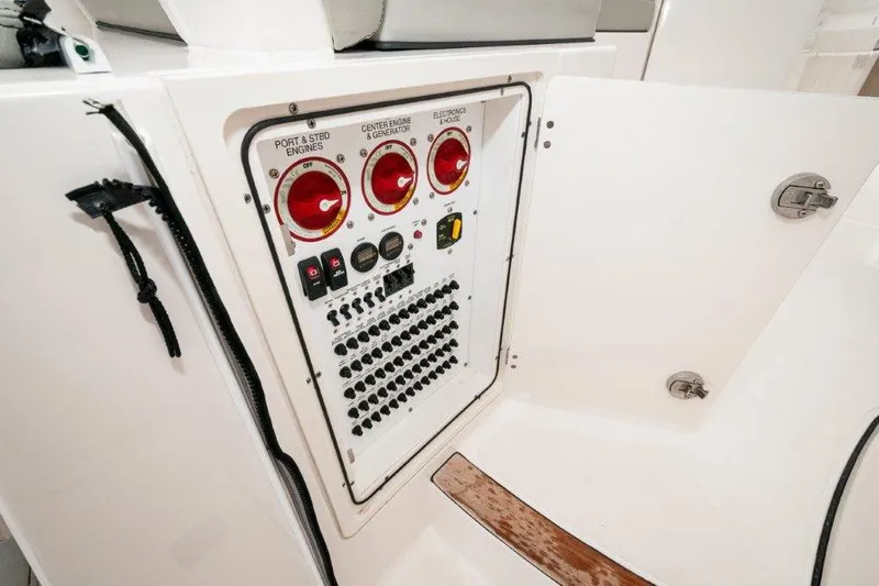 Silver Lining Yacht Photos Pics Control panel of 2023 Pursuit DC 365 Dual Console boat, featuring engine and electronics switches.