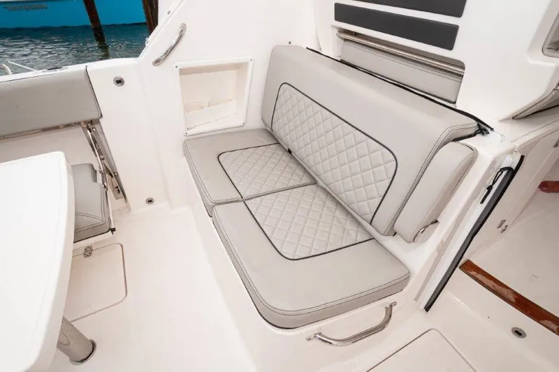 Silver Lining Yacht Photos Pics 2023 Pursuit DC 365 Dual Console boat interior with quilted seating and storage.