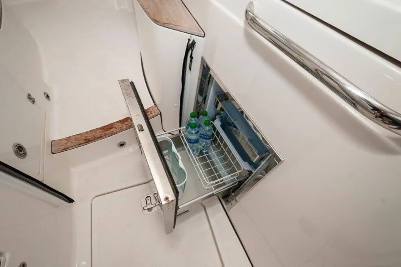 Silver Lining Yacht Photos Pics 2023 Pursuit DC 365 Dual Console boat with open storage compartment and water bottles.