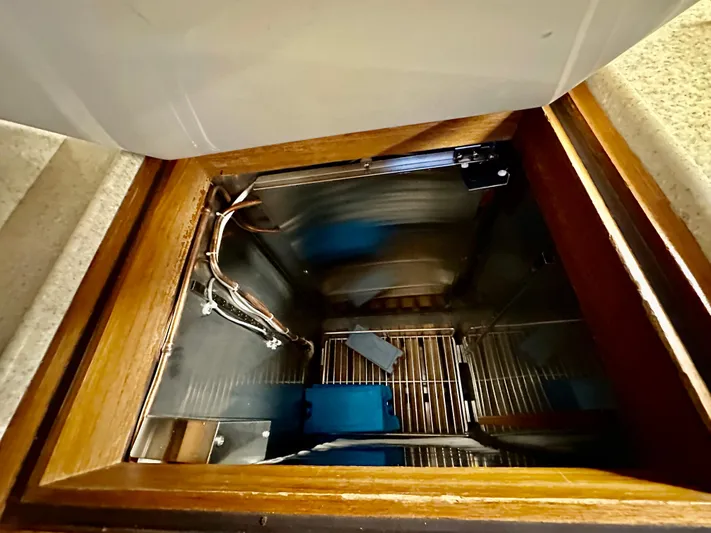 Moonshadow Yacht Photos Pics 2004 Grand Banks 49 Eastbay HX interior compartment with wooden frame and metal wiring.