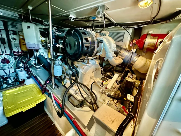 Moonshadow Yacht Photos Pics Engine room of 2004 Grand Banks 49 Eastbay HX, showcasing mechanical components and wiring.