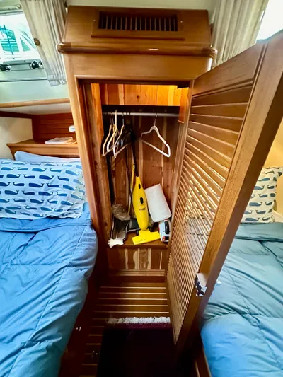 Moonshadow Yacht Photos Pics Wooden closet in 2004 Grand Banks 49 Eastbay HX cabin with blue bedding.