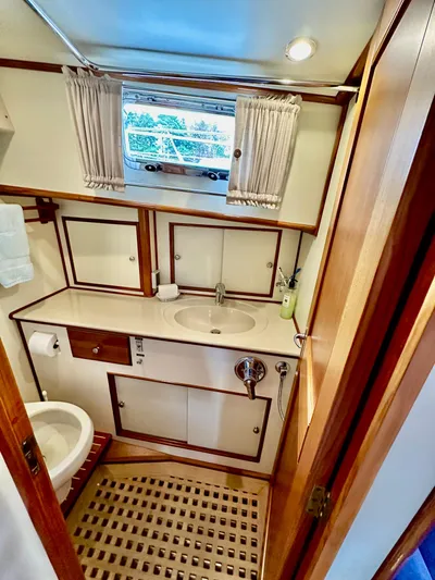 Moonshadow Yacht Photos Pics Luxurious 2004 Grand Banks 49 Eastbay HX yacht bathroom with elegant wood accents and modern fixtures.