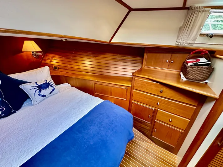 Moonshadow Yacht Photos Pics Luxurious 2004 Grand Banks 49 Eastbay HX cabin with wooden interior and cozy bedding.