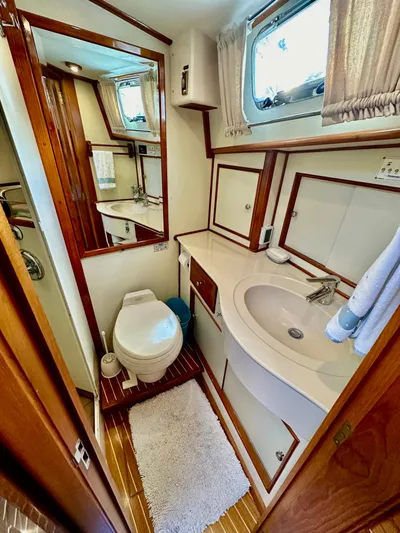 Moonshadow Yacht Photos Pics 2004 Grand Banks 49 Eastbay HX yacht bathroom with sink, toilet, and mirror.