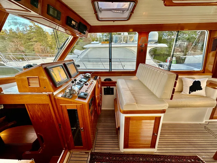 Moonshadow Yacht Photos Pics 2004 Grand Banks 49 Eastbay HX yacht interior with helm, navigation screens, and seating area.