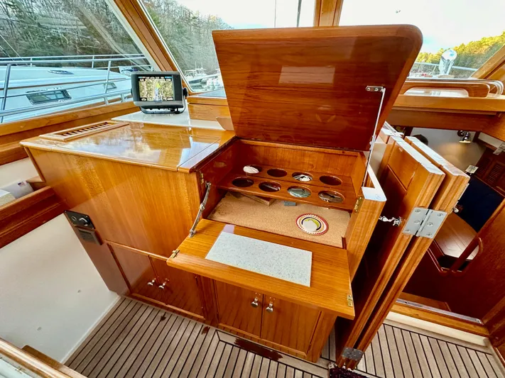 Moonshadow Yacht Photos Pics 2004 Grand Banks 49 Eastbay HX interior with wooden cabinetry and navigation equipment.